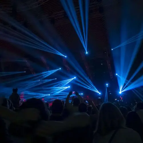 People in the night club with blue lights on them