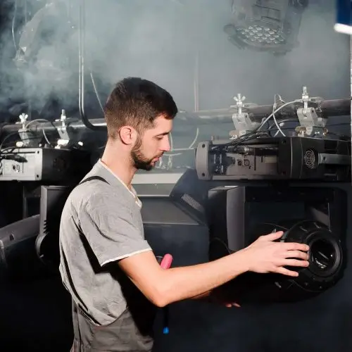 The stage worker sets up the lights